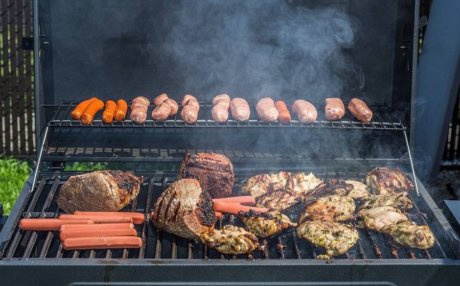 Steaks, chicken and sausages cooking on a multi-burner gas grill (representative photo)